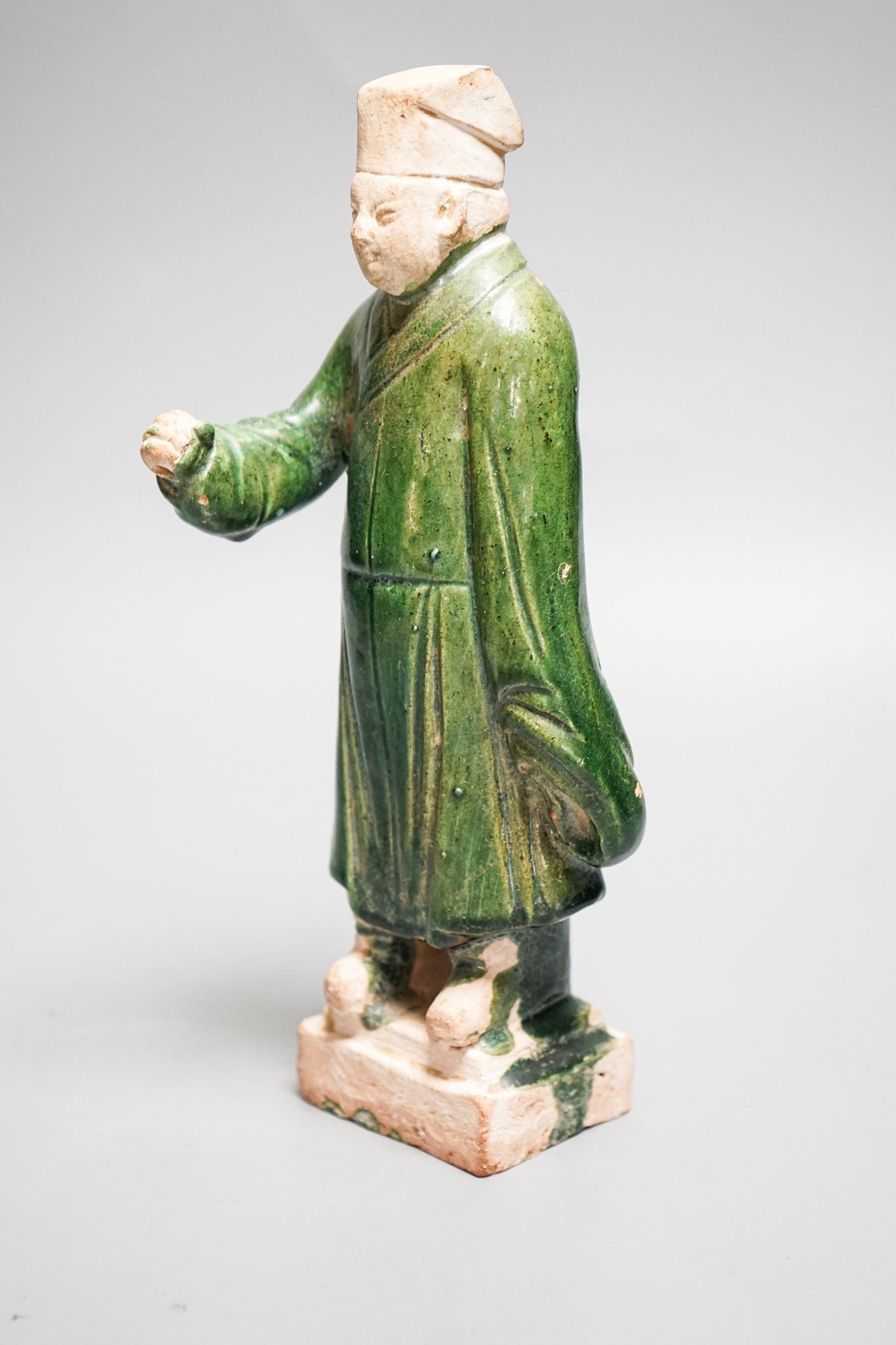 A Chinese Ming green glazed figure of an official 23cm
